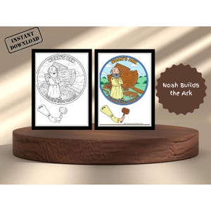 May include: Two framed prints of Noah's Ark illustrations. One is a black and white coloring page, the other is a colored version. Both feature Noah, the ark, and the text "Noah's Ark" and "Building God's Promise". A brown sign says "Noah Builds the Ark".