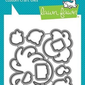 May include: A white card with a teal border features a die set with various ocean-themed shapes, including shells and bubbles. The text "lawn cuts custom craft dies" is at the top. The Lawn Fawn logo and a deer illustration are also present.