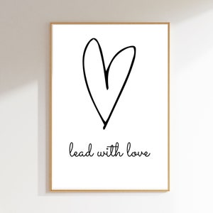 May include: A black and white printable wall art print with a hand-drawn heart and the text "lead with love".