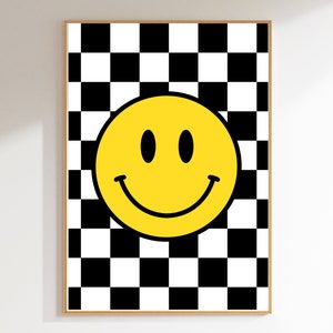May include: A yellow smiley face with black eyes and a black outline on a black and white chequered background.