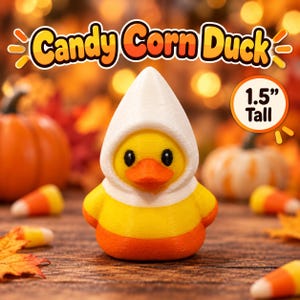 May include: A small duck figurine colored in horizontal bands of white, yellow, and orange, resembling a piece of candy corn. The duck is 1.5 inches tall, with black eyes and an orange beak. The text Candy Corn Duck is displayed above.