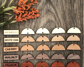 May include: A set of 20 unfinished wood half-circle shapes in various wood stains. The wood types are labeled: Unfinished, White Oak, Cherry, Walnut, and Padauk.