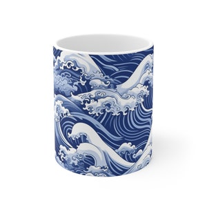 May include: A white ceramic mug with a blue and white wave pattern. The waves are stylized and resemble traditional Japanese art.