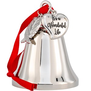 May include: A silver-colored bell ornament with a red ribbon. The ornament has a heart-shaped charm that reads "It's a Wonderful Life." There is also a silver wing charm. The bell is reflective and has a classic shape.