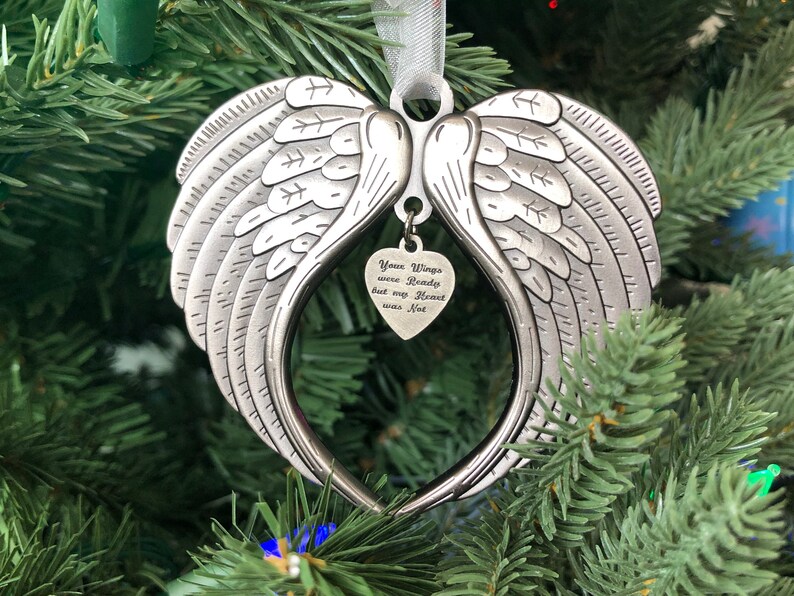 May include: Silver angel wing ornament with a heart-shaped charm that reads "Your Wings were Ready but my Heart was Not".