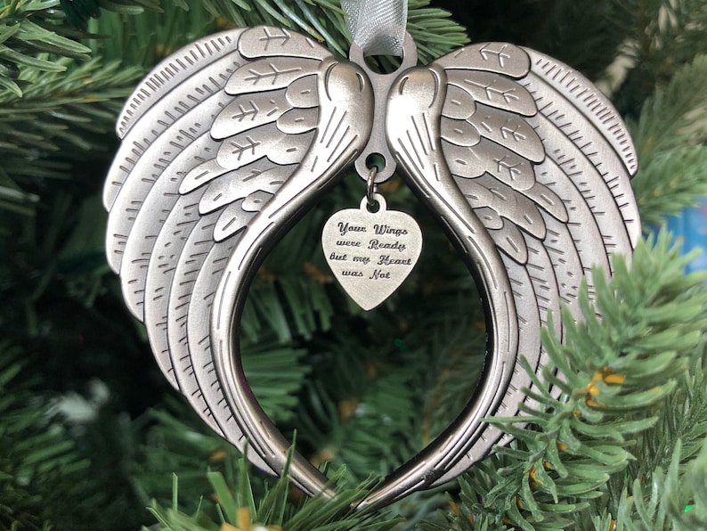 May include: Silver angel wings ornament with a heart-shaped charm that reads "Your Wings were Ready but my Heart was Not".