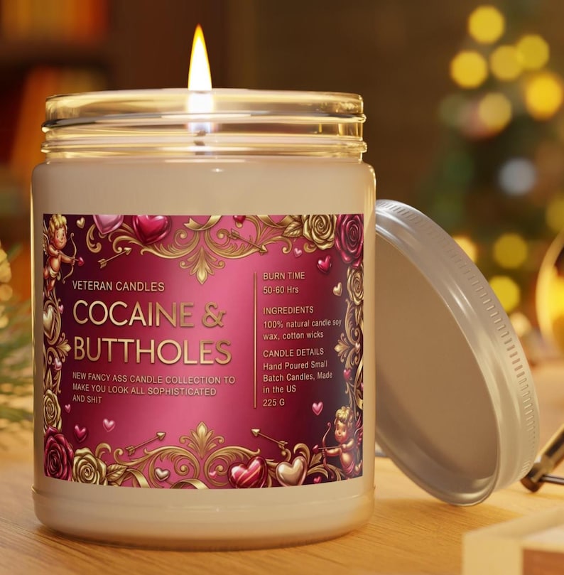 Peut inclure: Une bougie allum&eacute;e dans un bocal en verre avec un couvercle. L'&eacute;tiquette indique "COCAINE & BUTTHOLES" avec du texte suppl&eacute;mentaire. La bougie a une &eacute;tiquette rose et dor&eacute;e avec des &eacute;l&eacute;ments d&eacute;coratifs. Le bocal est sur une surface en bois.