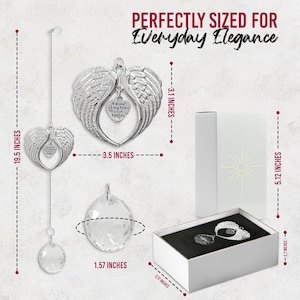 May include: A silver-colored angel wing ornament with a heart-shaped pendant that reads "a piece of my heart is in heaven." The ornament is 19.5 inches long and 3.5 inches wide. A crystal ball and a gift box are also shown.