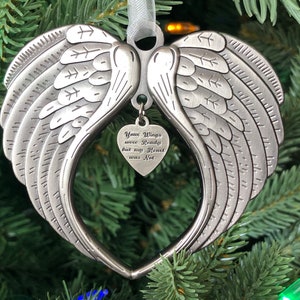 May include: Silver angel wing ornament with a heart-shaped charm that reads "Your Wings were Ready but my Heart was Not".