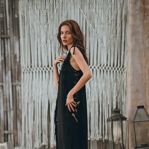 Fabulously Flowing – Step out in style with this stunning black see-through dress! This aesthetically pleasing piece is handmade from organically dyed cotton and features a beautiful flowing design.