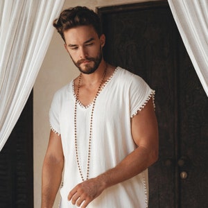 Create a classic and effortless look with this Boho-style off-white T-shirt topped off with handmade details. Pick out the perfect fit with sizes ranging from S–XL. Buy now and start enjoying the unique style of this Boho shirt for men!