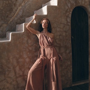 Take Your Look to the Next Level with Our Uniquely Handcrafted Cold Shoulder Jumpsuit. Our Dusty Pink Romper for Women Makes Perfect Sense in Your Closet.