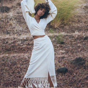 Capture the trend of Tribal Womens Clothing with this handcrafted Off-White Goddess Tassels Skirt.