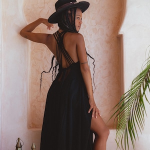 Feel empowered and look incredible in this boho goddess dress with a low-back slit, handmade macramé and empire waist.