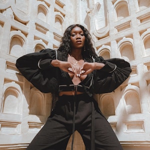 Timeless Black Chic: Our New Sexy Top is designed for the modern woman. The perfect blend of puff sleeves and hand embroidery adds allure to any outfit.