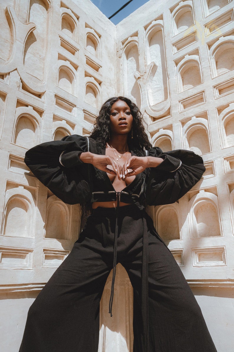 Timeless Black Chic: Our New Sexy Top is designed for the modern woman. The perfect blend of puff sleeves and hand embroidery adds allure to any outfit.