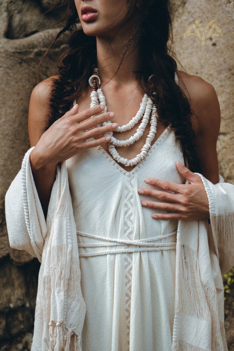Grecian beauty at its most breathtaking! Look like a goddess in this Grecian Wedding Dress, featuring off white and ivory hand embroidery andorganic cotton fabric.