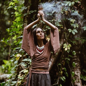 Embrace your spirituality with this Shamanic Wrap Blouse. The comfortable linen fabric is perfect for all types of weather.