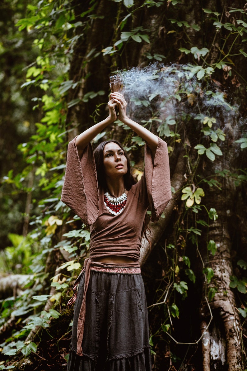 Embrace your spirituality with this Shamanic Wrap Blouse. The comfortable linen fabric is perfect for all types of weather.