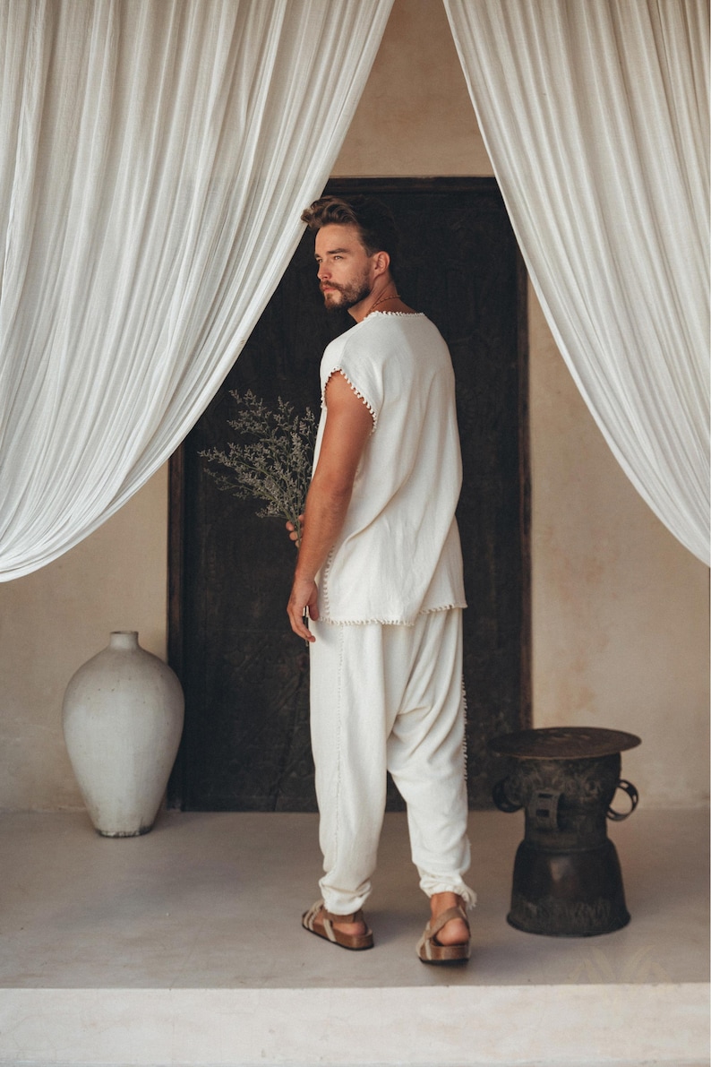 Showcasing handmade craftsmanship, this Boho shirt for men has an off-white T-shirt base with detailed knot work, creating a stunning piece of fashion. Take your look to the next level by selecting the perfect size from the size range options.