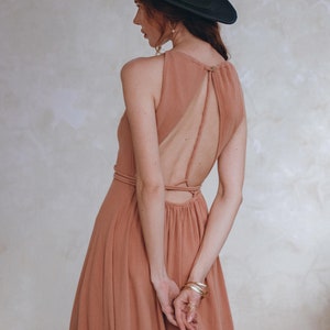 Feel like a princess in any official event. Our dusty pink maxi dress with open back and laced waist will turn heads!
