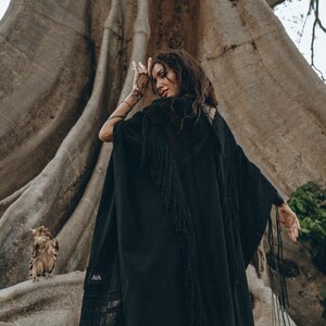 Step into the new season in style with our Bohemian Black Long Poncho, available in sizes XS/S/M/L.