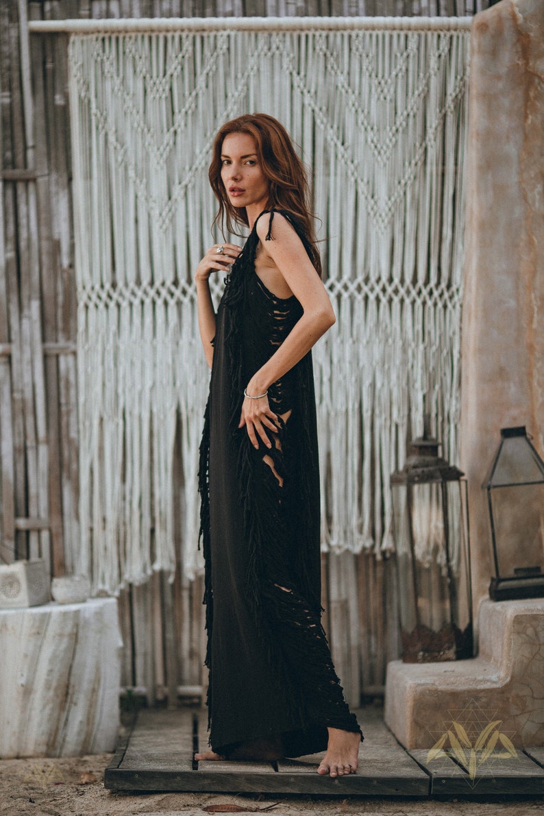 Fabulously Flowing – Step out in style with this stunning black see-through dress! This aesthetically pleasing piece is handmade from organically dyed cotton and features a beautiful flowing design.