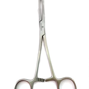 May include: A stainless steel surgical hemostat forceps with serrated jaws and finger rings. The forceps are marked with the brand name "boromed". The tool is designed for grasping and holding tissues or objects during medical procedures.