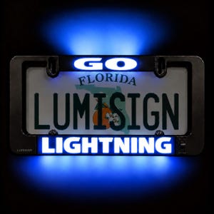May include: A black rectangular license plate frame with integrated blue LED lighting. The top bar displays the word GO in white, while the bottom bar displays the word LIGHTNING in white. The frame surrounds a Florida license plate.