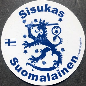 May include: A white round sticker featuring a blue lion holding a sword, encircled by blue flowers. The text "Sisu kas Suomalainen" is written in blue around the lion. The text "© 2019 GutsyFinn" is written in blue on the right side of the sticker.