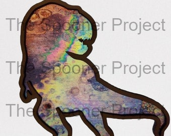 May include: A wooden cutout of a Tyrannosaurus Rex dinosaur with a colorful, abstract design. The design features shades of blue, green, yellow, and pink.