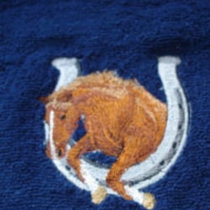 Towel embroidered with horse motif and name image 1