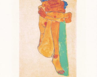 May include: An art print featuring a nude figure in a seated pose, rendered in warm orange and yellow tones with blue accents. The artwork is signed "Egon Schiele" and dated 1910. The print is on a cream-colored background.