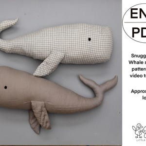 May include: Two stuffed whale plushies. One is light gray with a gingham pattern, the other is solid taupe. Each has a tail, fins, and a small black eye. The image includes text that says "Snuggle the Whale sewing pattern and video tutorial". The whales are approximately 23 inches long.