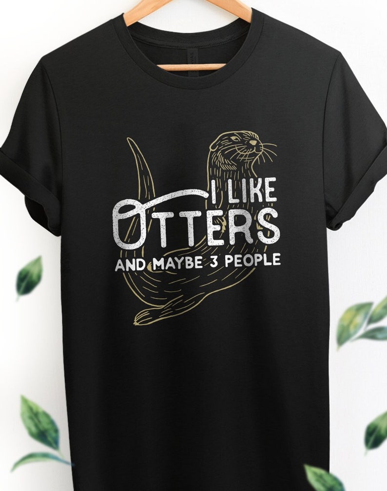 May include: Black t-shirt with a graphic of an otter and the text "I like otters and maybe 3 people".