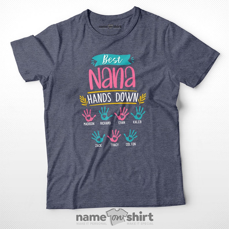 May include: A navy blue t-shirt with the text "Best Nana Hands Down" in pink, yellow, and blue.  The shirt features a design of colorful handprints with names written underneath: Madison, Richard, Evan, Kaleb, Zack, Tracy, and Colton.
