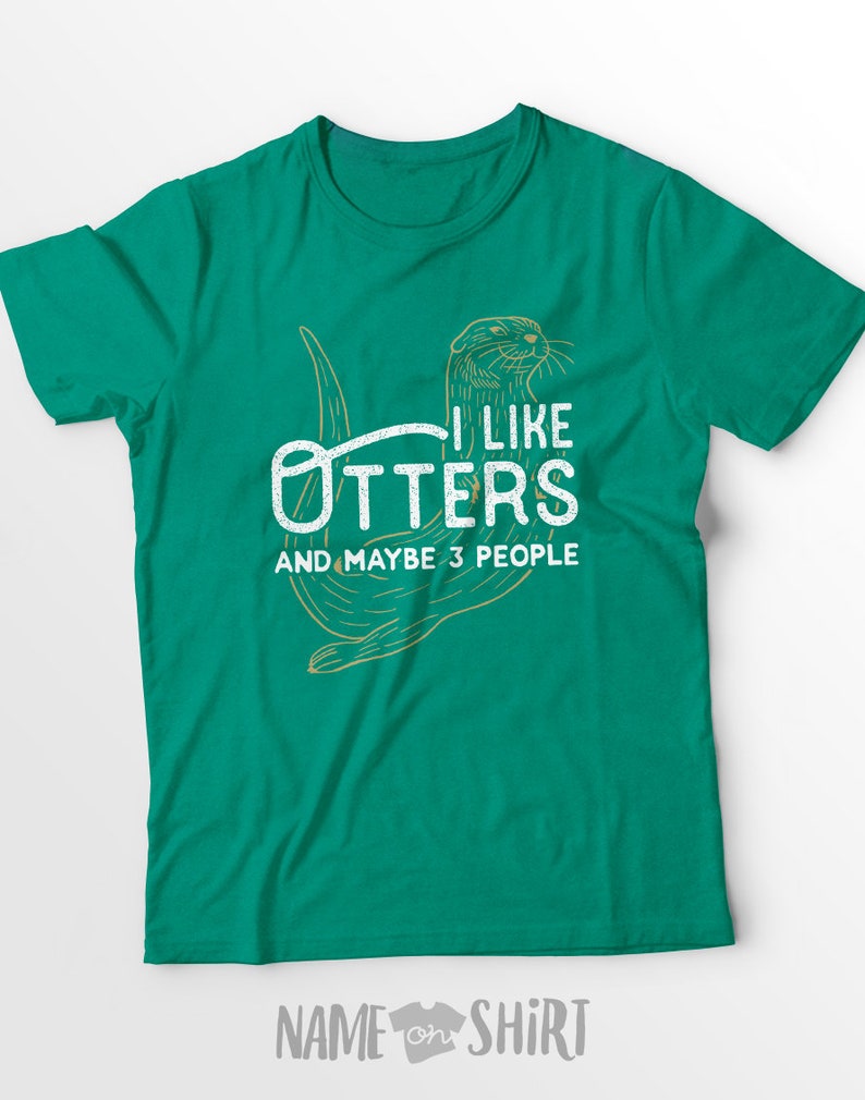 May include: A green t-shirt with a white graphic of an otter and the text "I like otters and maybe 3 people".