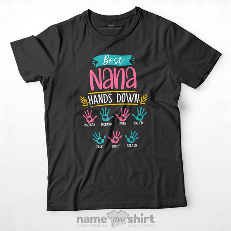 May include: Black t-shirt with the text "Best Nana Hands Down" in pink and yellow.  There are six handprints in pink and blue with names written below each handprint: Madison, Richard, Evan, Caleb, Zack, Tracy, and Colton.