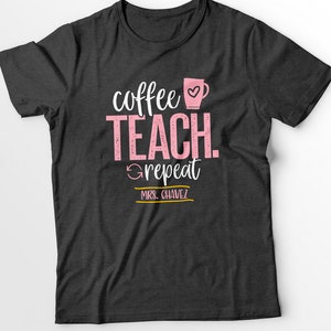 May include: Dark grey t-shirt with a pink coffee cup and the text "coffee teach repeat" and "MRS. CHAVEZ" in a yellow banner.