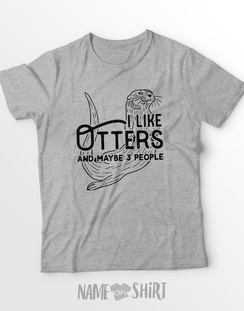 May include: Gray t-shirt with a black and white illustration of an otter. The text "I like otters and maybe 3 people" is printed on the shirt.