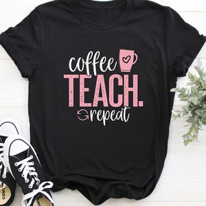 May include: Black t-shirt with pink text that reads "coffee teach repeat" and a pink coffee cup with a heart.