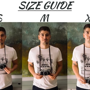May include: Size guide for a white t-shirt with a palm tree graphic and a brown camera strap. The guide shows three sizes: S, M, and XL.