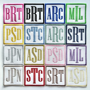 May include: A selection of embroidered patches, each featuring a three-letter monogram in a range of colours. The patches are square, with a white background and a coloured border. The letters are in a traditional serif font.