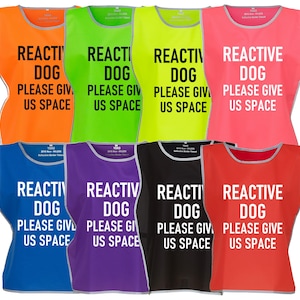 May include: A set of 8 safety vests for dogs, in various colours, with the text "REACTIVE DOG PLEASE GIVE US SPACE" printed in white on each vest.