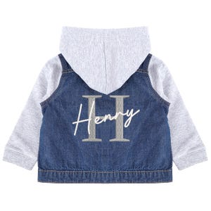 May include: A children's denim jacket with a grey hood and sleeves. The back of the jacket has the name "Henry" in cursive, with the letter "H" in a bold, grey colour.