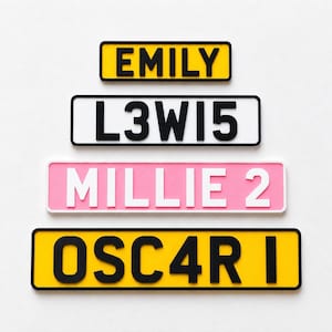May include: Four rectangular signs with rounded corners. The top sign is yellow with black text EMILY. The second is white with black text L3W15. The third is pink with white text MILLIE 2. The bottom sign is yellow with black text OSC4R I.