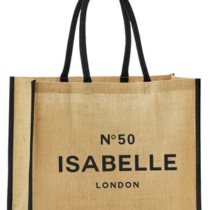 May include: A beige jute tote bag with black handles and trim. The bag has the text "N&deg;50 ISABELLE LONDON" printed on the front.