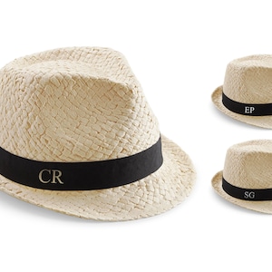 May include: Three straw hats with black bands and gold initials. The hats are all the same style, but have different initials: CR, EP, and SG.