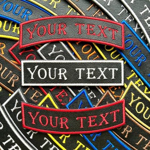 May include: Close-up of custom embroidered patches with the text "YOUR TEXT" in red and white. The patches are black with various coloured borders and text, including "OUR TEXT". These patches are ideal for customising apparel.