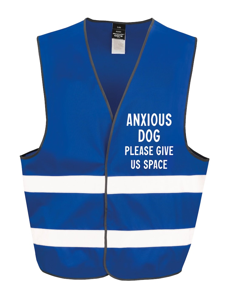 May include: A blue safety vest with white reflective stripes and the text "ANXIOUS DOG PLEASE GIVE US SPACE" in white. The vest has a V-neck and a gray trim. The vest is designed for dogs.